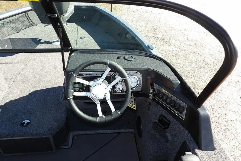 Slide: The Image of 2026 Lund 2075 Impact XS boat dashboard with steering wheel and control panel. - 23