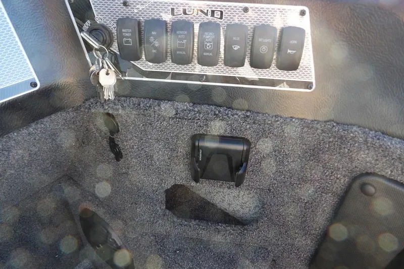 Slide: The Image of Control panel of 2026 Lund 2075 Impact XS boat with keys and switches. - 24