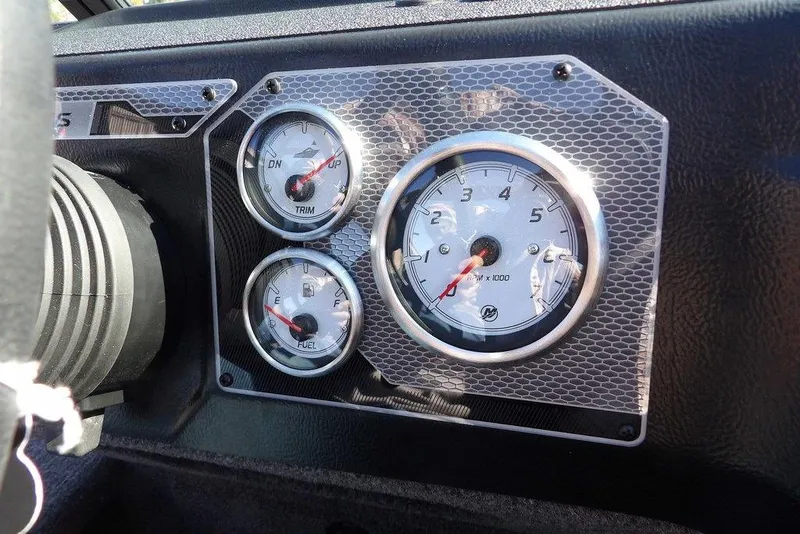 Slide: The Image of Dashboard of 2026 Lund 2075 Impact XS boat with gauges for trim, fuel, and RPM. - 25