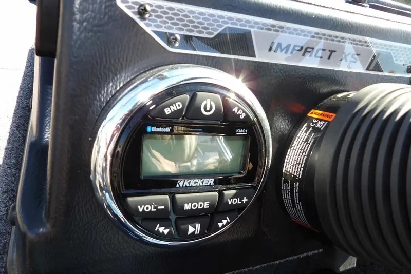 Slide: The Image of 2026 Lund 2075 Impact XS boat dashboard with Kicker Bluetooth audio system. - 26