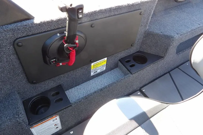 Slide: The Image of 2026 Lund 2075 Impact XS boat interior with control panel and cup holders. - 29