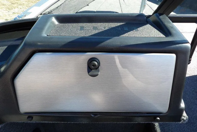 Slide: The Image of 2026 Lund 2075 Impact XS boat dashboard with sleek metallic finish and secure lock. - 30