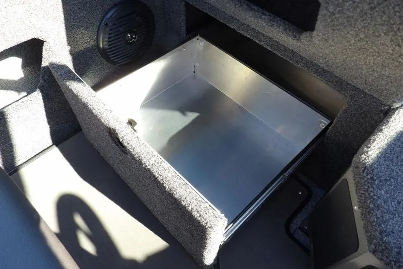 Slide: The Image of 2026 Lund 2075 Impact XS boat storage compartment with speaker, open and empty. - 34