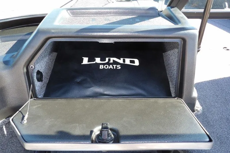Slide: The Image of 2026 Lund 2075 Impact XS boat storage compartment with logo. - 36