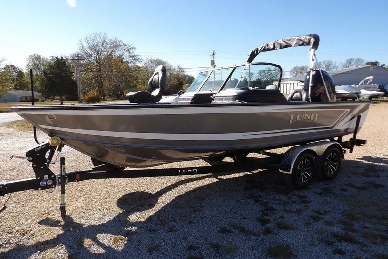 Slide: The Image of 2026 Lund 2075 Impact XS boat on trailer, parked outdoors. - 4