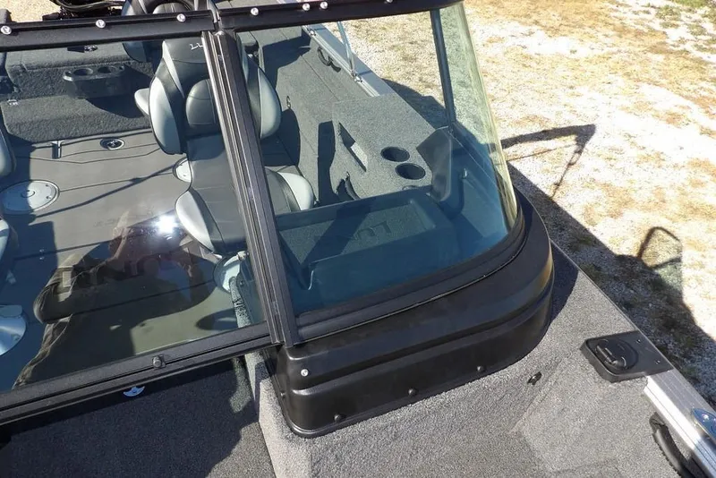 Slide: The Image of 2026 Lund 2075 Impact XS boat interior with seating and windshield view. - 46