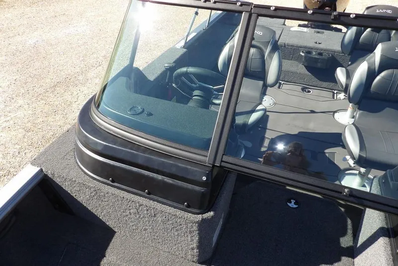 Slide: The Image of 2026 Lund 2075 Impact XS boat interior with seating and windshield. - 47