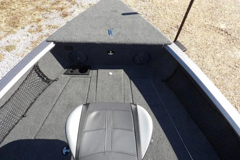 Slide: The Image of 2026 Lund 2075 Impact XS boat interior with gray carpet and seating. - 48