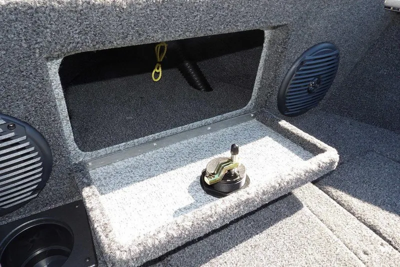 Slide: The Image of 2026 Lund 2075 Impact XS boat interior with storage compartment and speaker. - 49