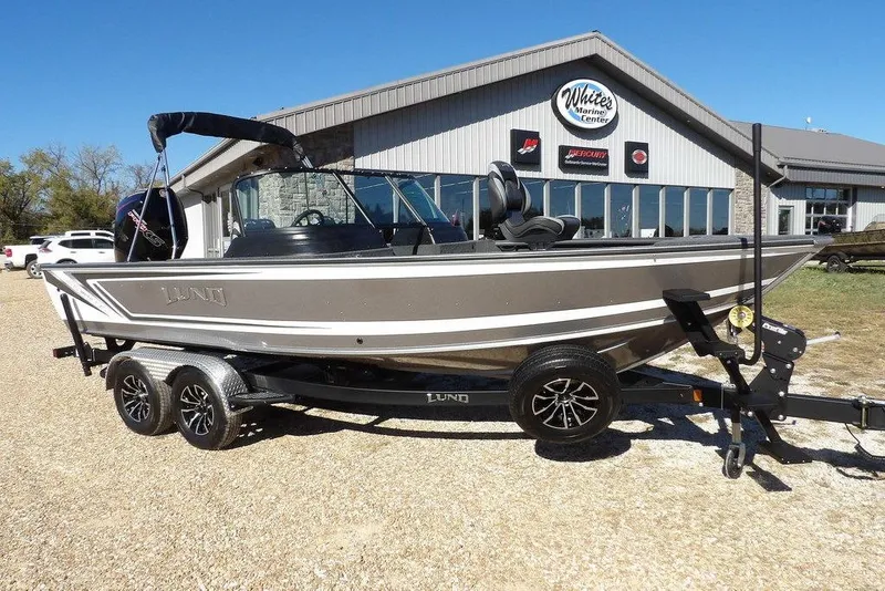 Slide: The Image of 2026 Lund 2075 Impact XS boat on trailer outside marine center. - 5