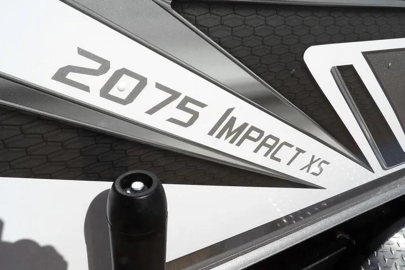 Slide: The Image of 2026 Lund 2075 Impact XS boat logo on sleek black and white design. - 52