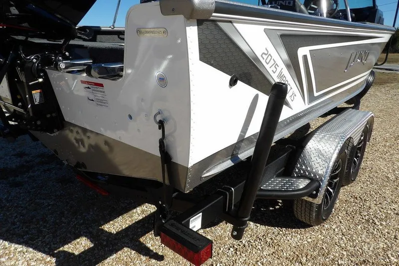 Slide: The Image of 2026 Lund 2075 Impact XS boat on trailer, rear view, showcasing design and features. - 53