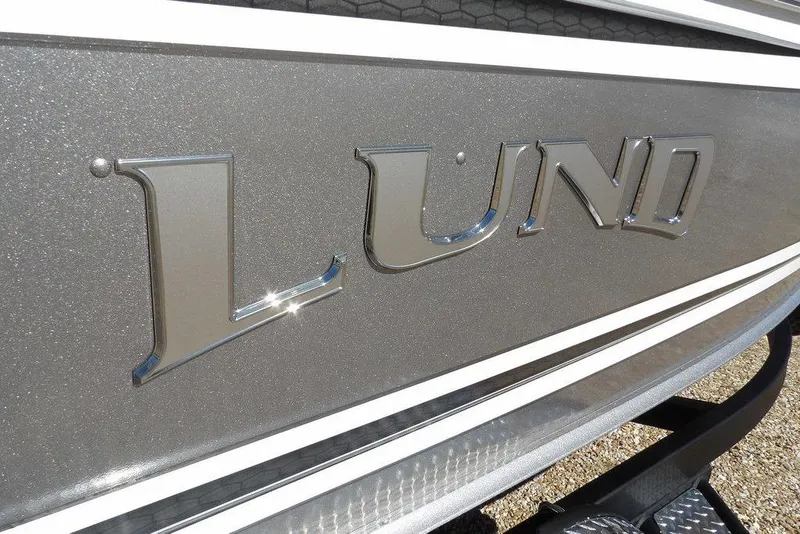 Slide: The Image of Close-up of 2026 Lund 2075 Impact XS boat logo on metallic surface. - 54
