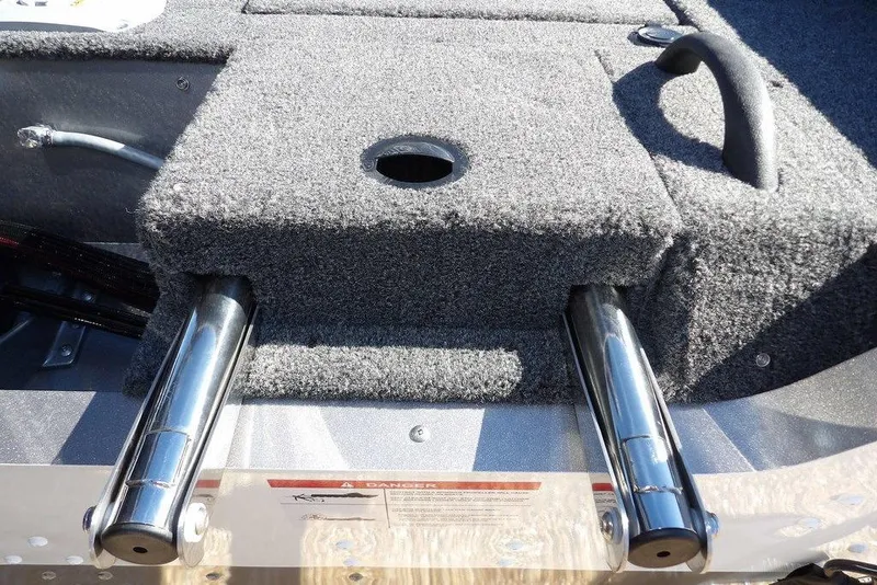 Slide: The Image of 2026 Lund 2075 Impact XS boat interior with carpeted surface and metal fixtures. - 56