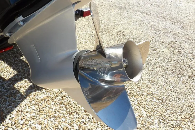 Slide: The Image of Propeller of 2026 Lund 2075 Impact XS boat on gravel surface. - 57