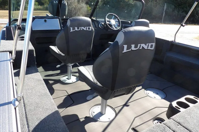 Slide: The Image of 2026 Lund 2075 Impact XS boat interior with two branded seats and console. - 9