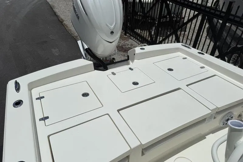 Slide: The Image of 2025 Pathfinder 2600 TRS boat deck with storage compartments and outboard motor. - 10
