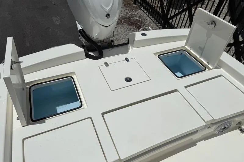 Slide: The Image of 2025 Pathfinder 2600 TRS boat deck with storage compartments and motor. - 11