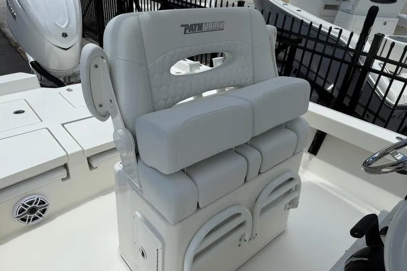 Slide: The Image of 2025 Pathfinder 2600 TRS boat seating with white cushioned design and storage compartments. - 13