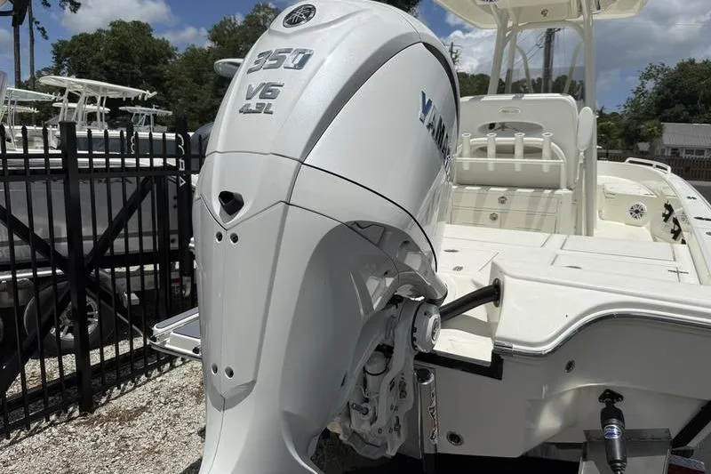 Slide: The Image of 2025 Pathfinder 2600 TRS boat with Yamaha 350 V6 engine, docked outdoors. - 16