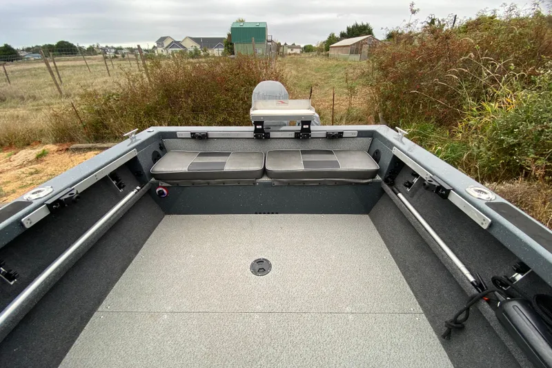 Slide: The Image of 2022 Duckworth 20XT Advantage boat interior with seating and storage, outdoors. - 13