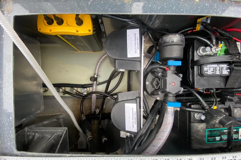 Slide: The Image of 2022 Duckworth 20XT Advantage boat engine compartment with fuel filters and battery connections. - 18