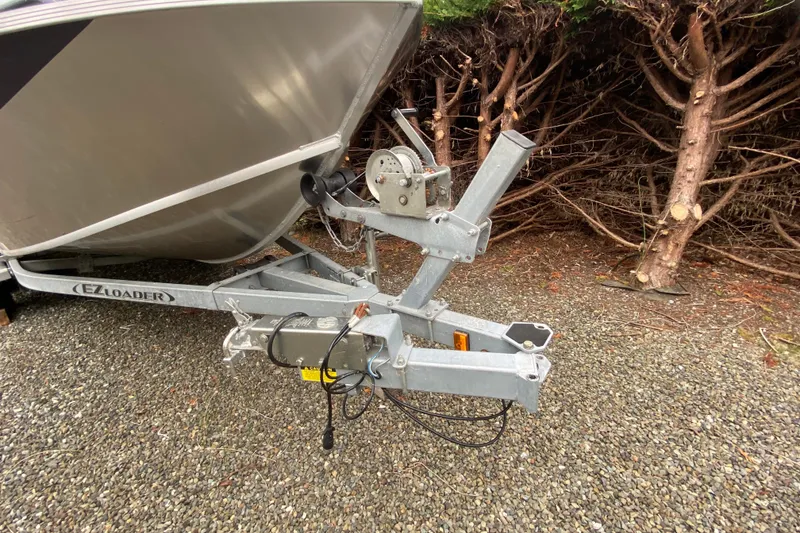 Slide: The Image of 2022 Duckworth 20XT Advantage boat on EZ Loader trailer, parked on gravel. - 22