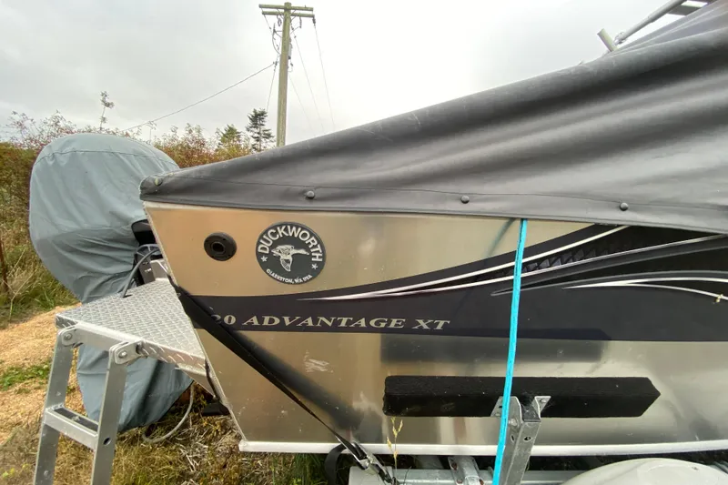 Slide: The Image of 2022 Duckworth 20XT Advantage boat with cover, parked outdoors. - 3