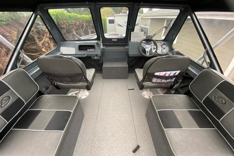 Slide: The Image of Interior of a 2022 Duckworth 20XT Advantage boat, featuring seating and control console. - 8