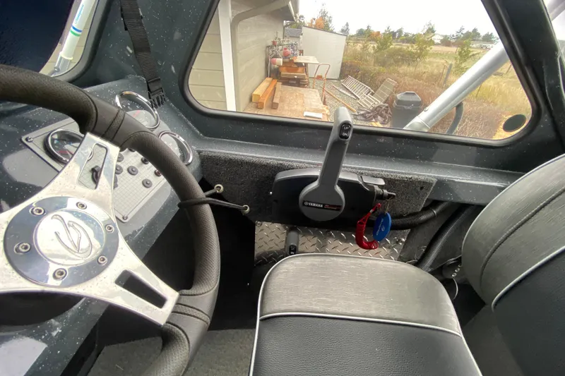 Slide: The Image of Interior of a 2022 Duckworth 20XT Advantage boat, featuring steering wheel and controls. - 9