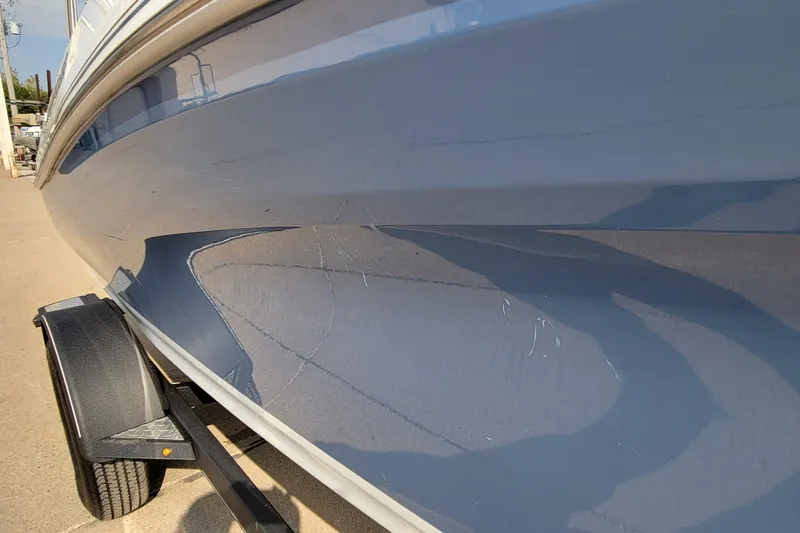 Slide: The Image of 2022 Tahoe 185 S WT boat side view on trailer, showcasing sleek blue hull design. - 22