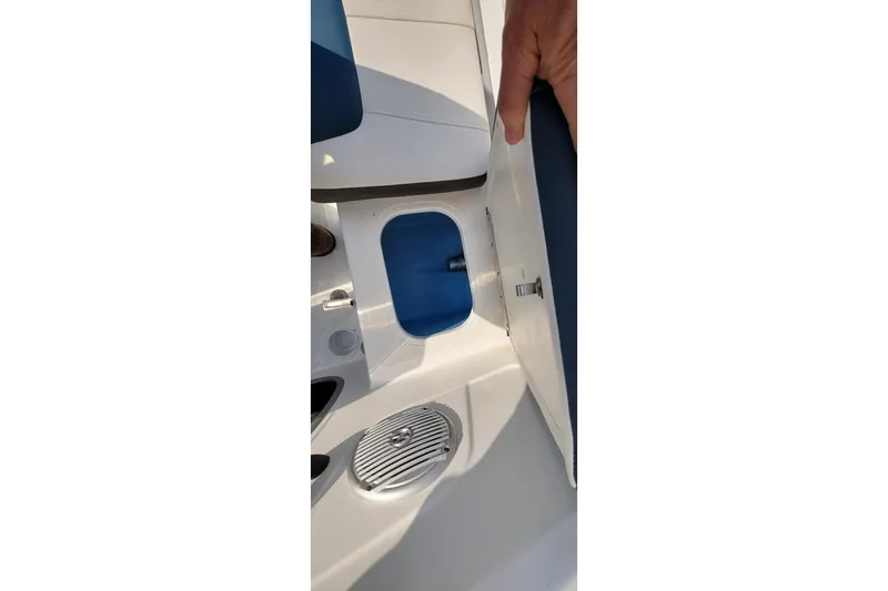 Slide: The Image of 2022 Tahoe 185 S WT boat interior storage compartment with blue lining and latch. - 26