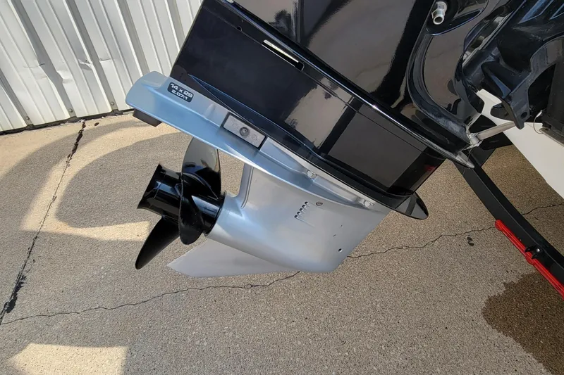 Slide: The Image of 2022 Tahoe 185 S WT boat propeller and lower unit on concrete surface. - 8