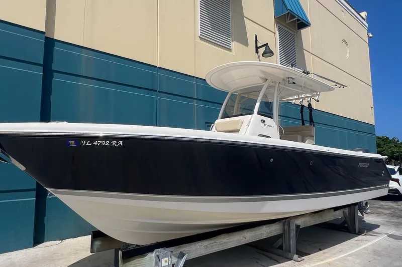 Slide: The Image of 2015 Pursuit C 260 Center Console boat displayed outdoors on a stand. - 0