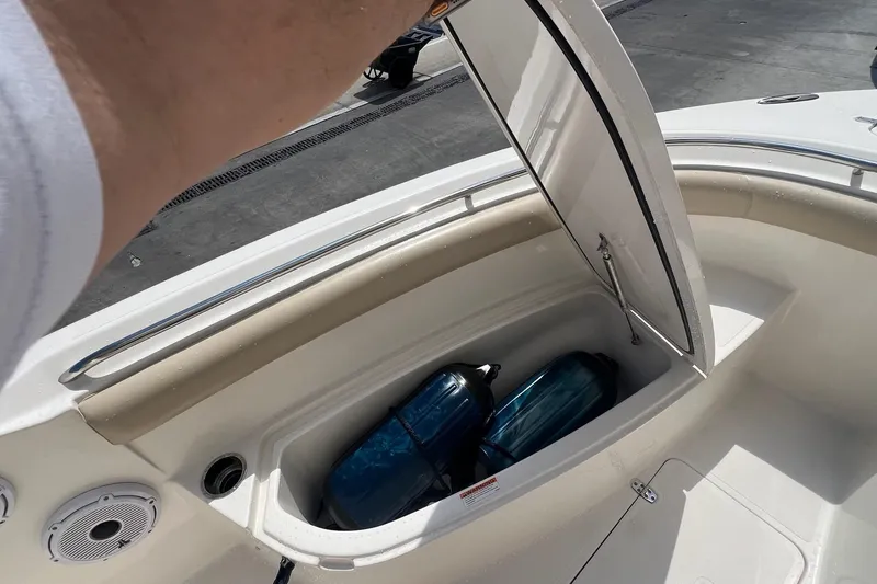 Slide: The Image of 2015 Pursuit C 260 Center Console boat storage compartment with fenders inside. - 10