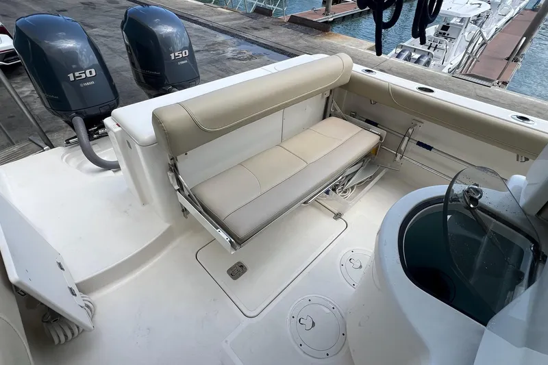Slide: The Image of 2015 Pursuit C 260 Center Console boat with dual Yamaha 150 engines and seating area. - 11