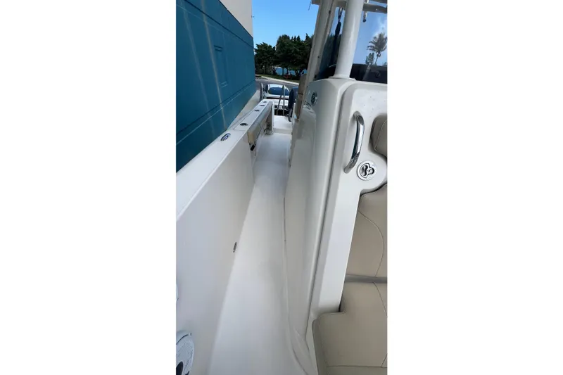 Slide: The Image of 2015 Pursuit C 260 Center Console boat, side view with seating and railing. - 13