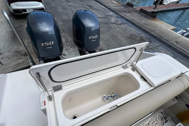 Slide: The Image of 2015 Pursuit C 260 Center Console with Yamaha 150 engines and open storage compartment. - 19