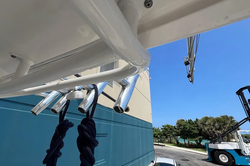 Slide: The Image of 2015 Pursuit C 260 Center Console boat with rod holders and blue ropes, dockside view. - 23