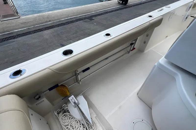 Slide: The Image of 2015 Pursuit C 260 Center Console boat interior with storage and fishing rod holders. - 24