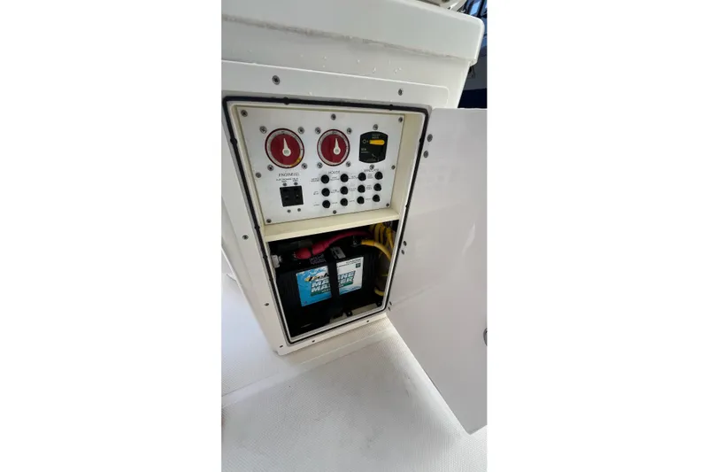 Slide: The Image of 2015 Pursuit C 260 Center Console battery compartment with control panel and switches. - 26