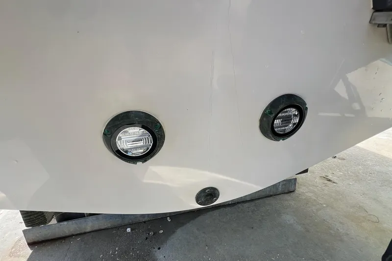 Slide: The Image of 2015 Pursuit C 260 Center Console boat with underwater lights on the hull. - 28