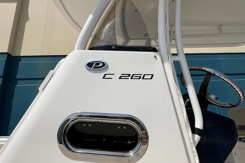 Slide: The Image of 2015 Pursuit C 260 Center Console boat, close-up of helm and logo. - 30