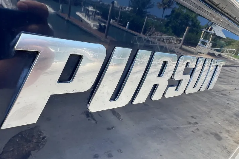 Slide: The Image of Chrome "Pursuit" logo on a 2015 C 260 Center Console boat. - 31
