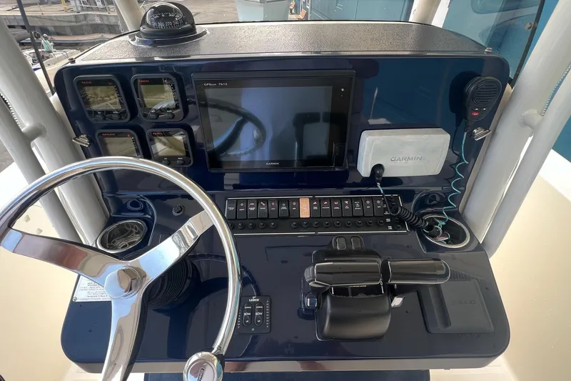 Slide: The Image of 2015 Pursuit C 260 Center Console helm with Garmin navigation and control panel. - 4