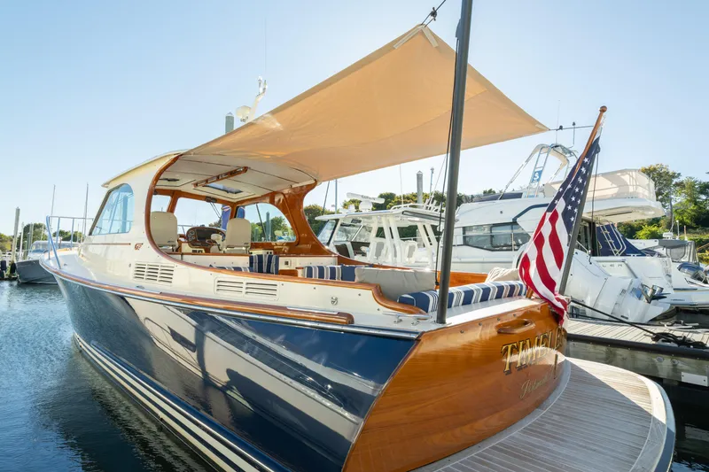 Slide: The Image of 2015 Hinckley Picnic Boat MK III docked with American flag and sunshade. - 10