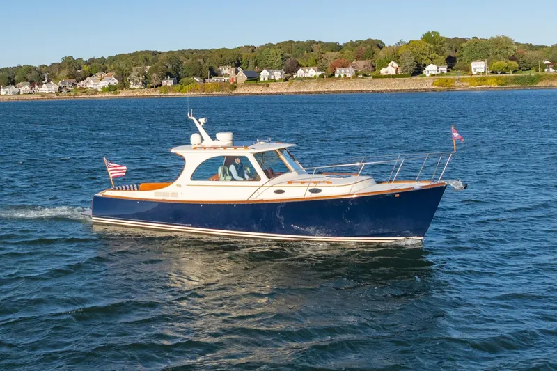 Slide: The Image of 2015 Hinckley Picnic Boat MK III cruising on a scenic waterway. - 31