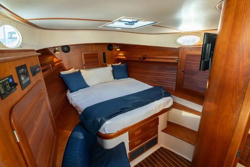 Slide: The Image of Luxurious 2015 Hinckley Picnic Boat MK III cabin with wood interior and cozy bed. - 27