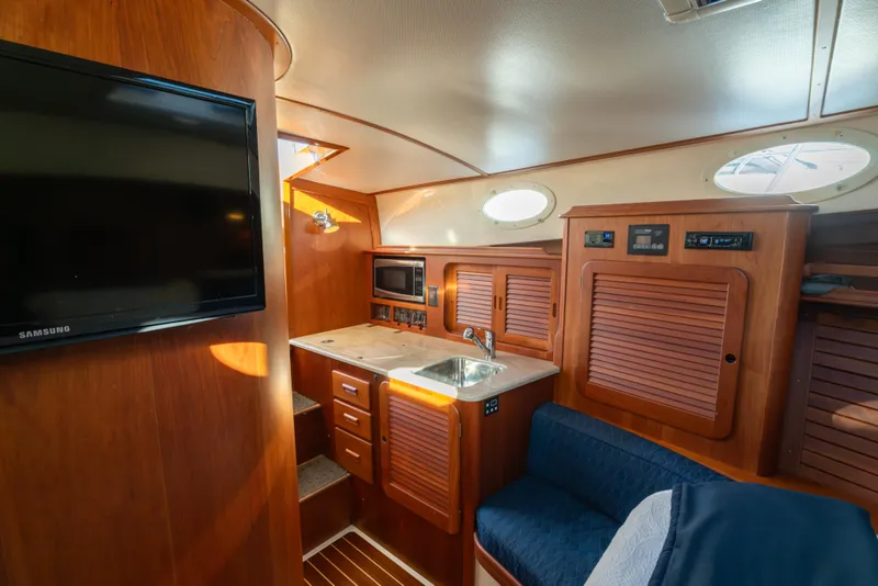 Slide: The Image of Interior of 2015 Hinckley Picnic Boat MK III with wood finish and modern amenities. - 28