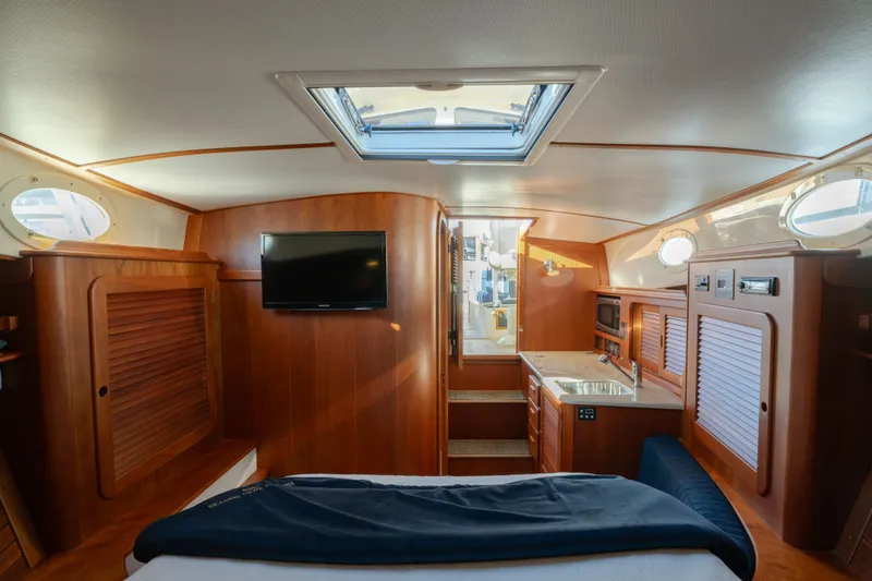 Slide: The Image of Luxurious interior of 2015 Hinckley Picnic Boat MK III with wood finish and modern amenities. - 30